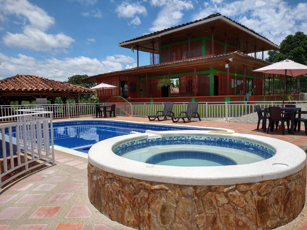 a large swimming pool with a building in the background at Finca La Gaviota in Montenegro