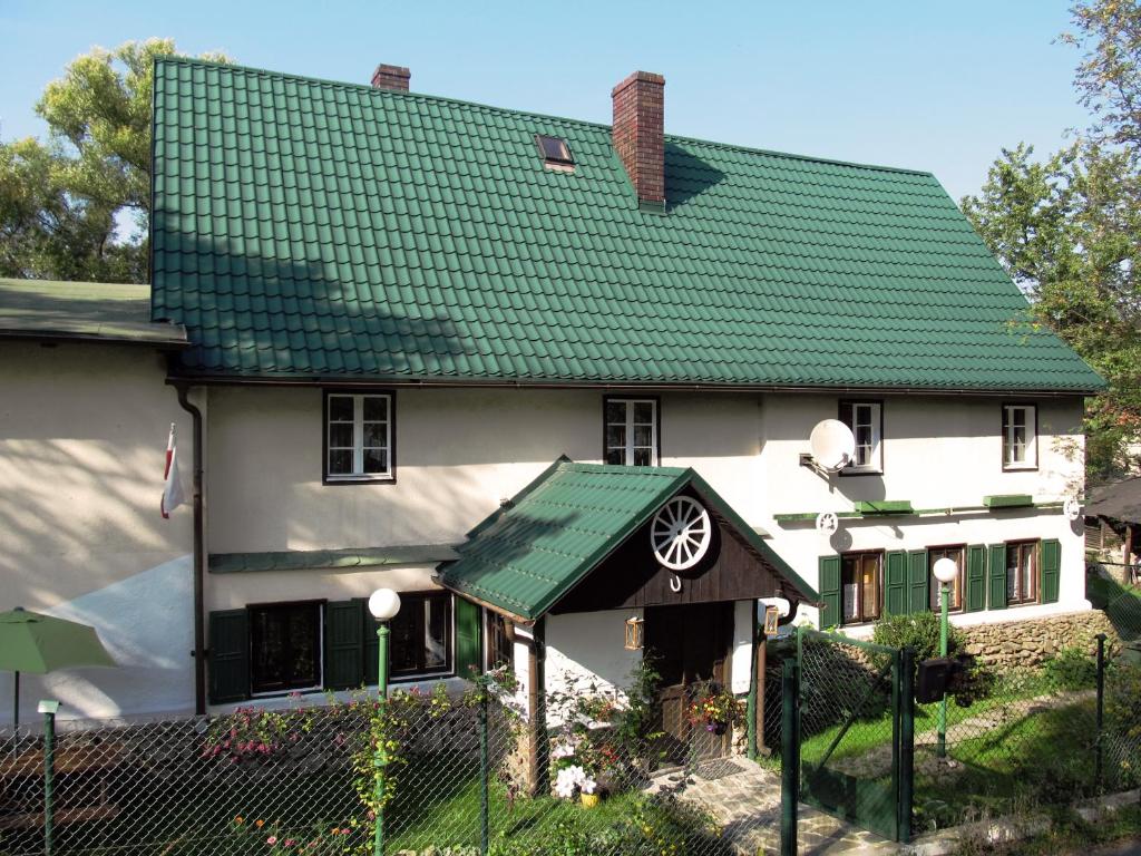 a large white house with a green roof at Chata za Górami in Zagórze Śląskie