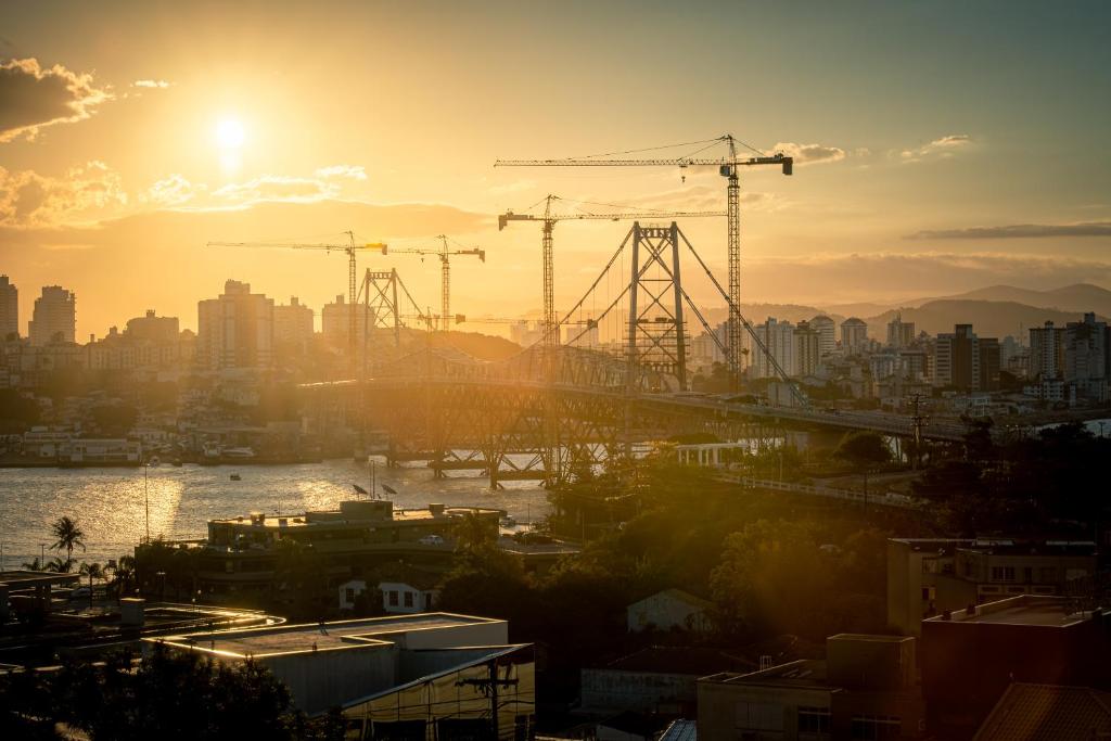 a view of a city with construction cranes at Lumar Hotel in Florianópolis