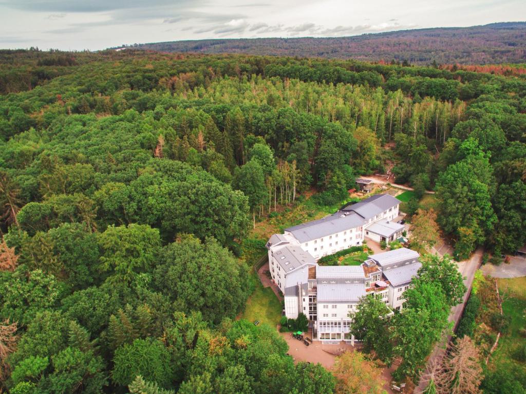 an aerial view of a building in the woods at TaunusTagungsHotel in Friedrichsdorf