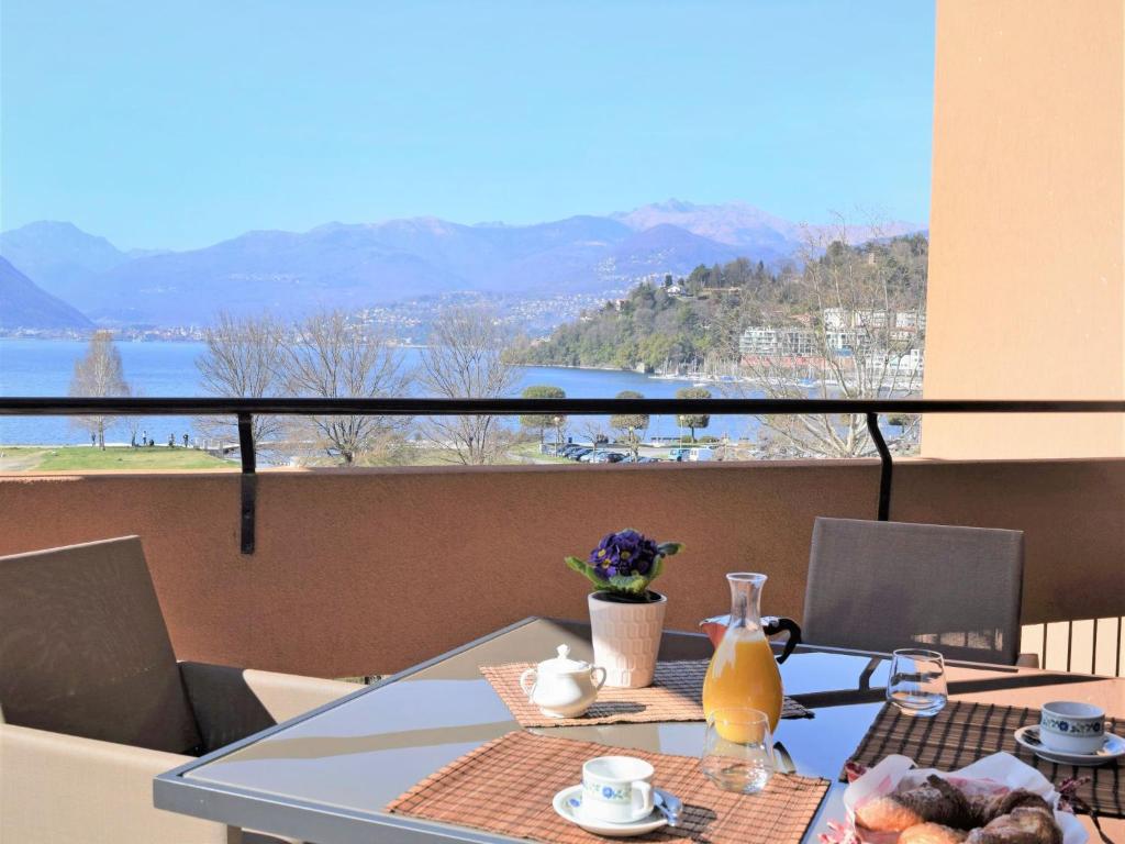 a dining table with a view of the water at Apartment La Perla di Laveno by Interhome in Laveno-Mombello