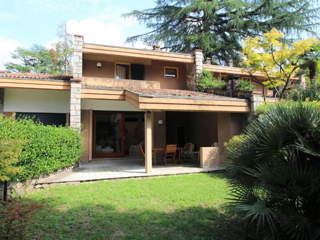 a house with a porch and a patio at Holiday Home Alpina by Interhome in Porto Valtravaglia