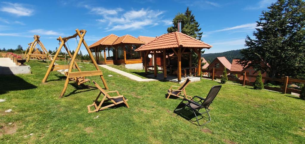 a playground with two chairs and a gazebo at Lodge Nagramak in Sekulić 