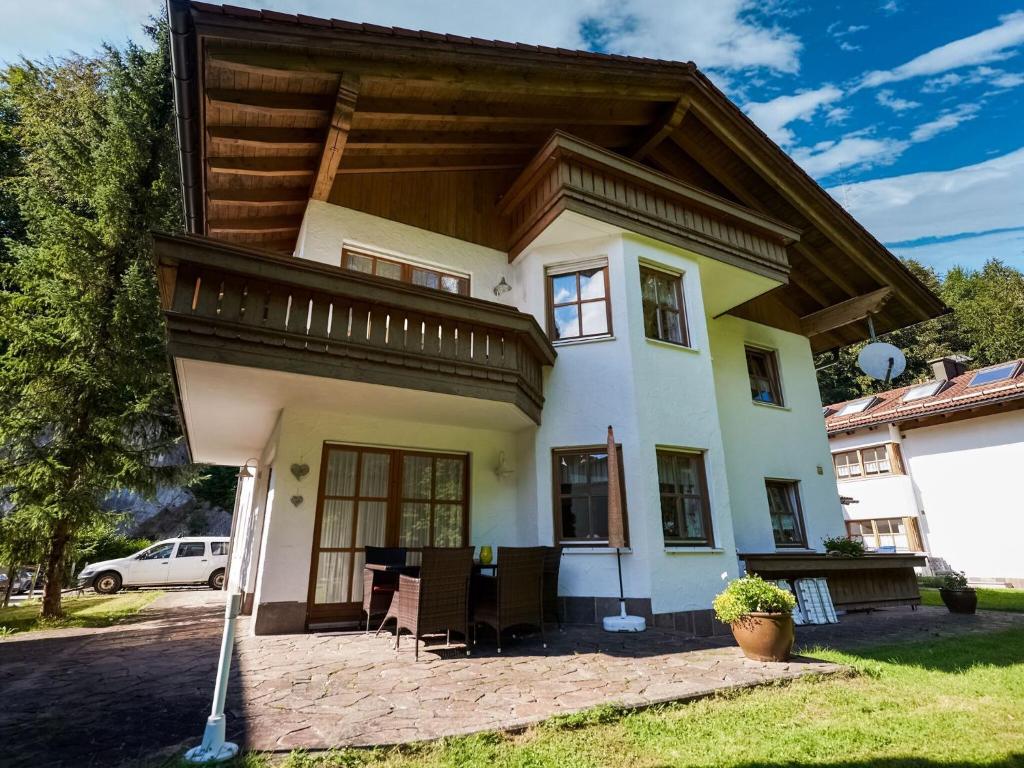 a large house with a wooden roof at Cosy apartment in Sch nau am K nigsee in a wooded location in Schönau am Königssee