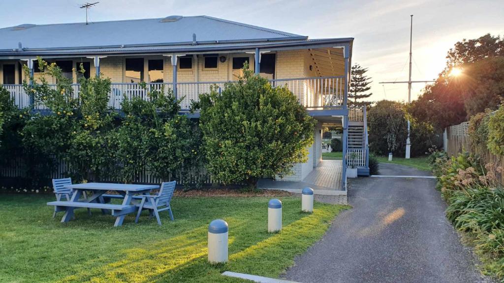 ein Haus mit einem Tisch und Stühlen im Hof in der Unterkunft Point Lonsdale Guest House in Point Lonsdale