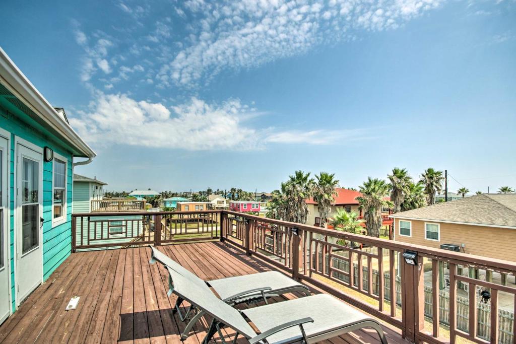a balcony with two chairs on a wooden deck at Surfside Retreat Steps to Beach and Local Eats! in Surfside Beach