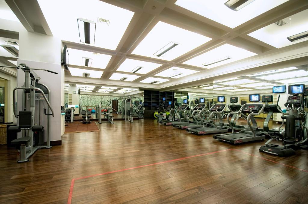 a gym with treadmills and elliptical machines at Belgravia Serviced Residence Wuxi in Wuxi