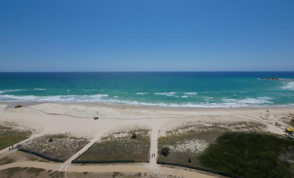 an aerial view of a beach and the ocean at Princess Palm on the Beach in Gold Coast