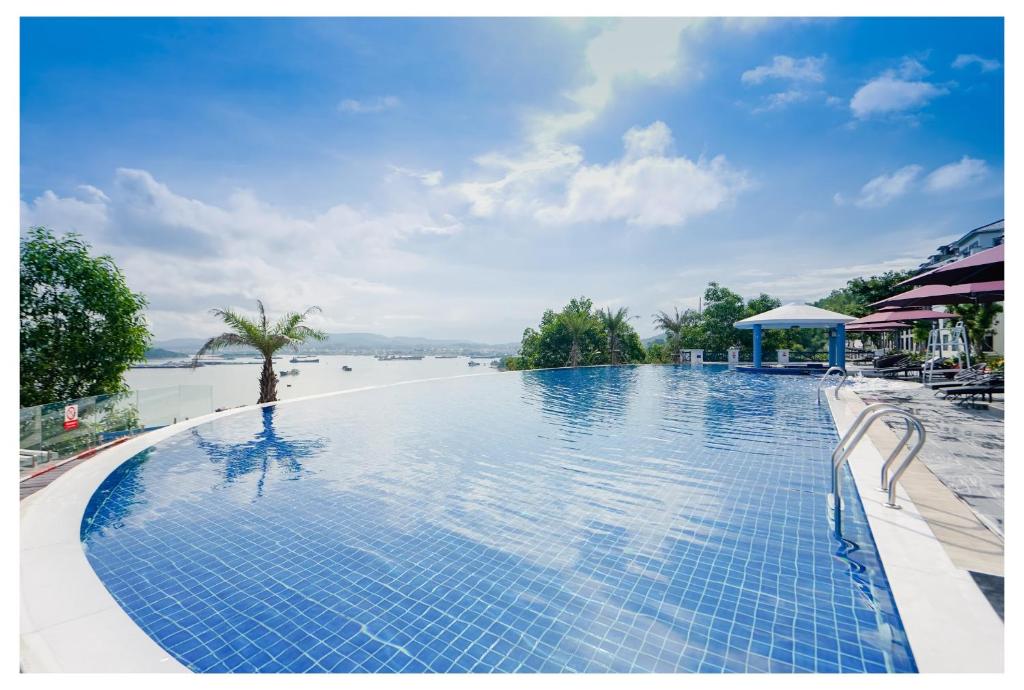 a swimming pool with a view of the water at D'Lioro Hotel & Resort in Ha Long