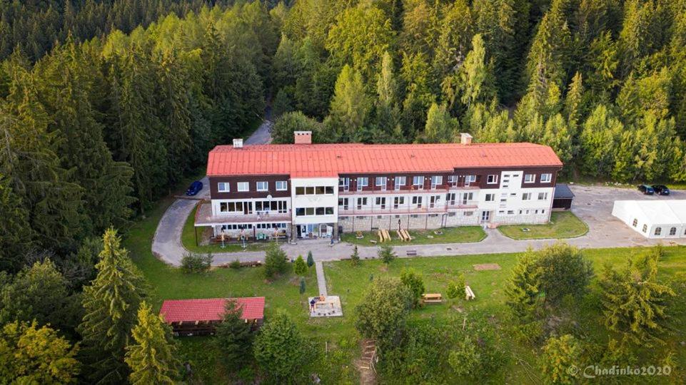 an aerial view of a large building with a red roof at Horský Hotel Vršky in Závadka nad Hronom