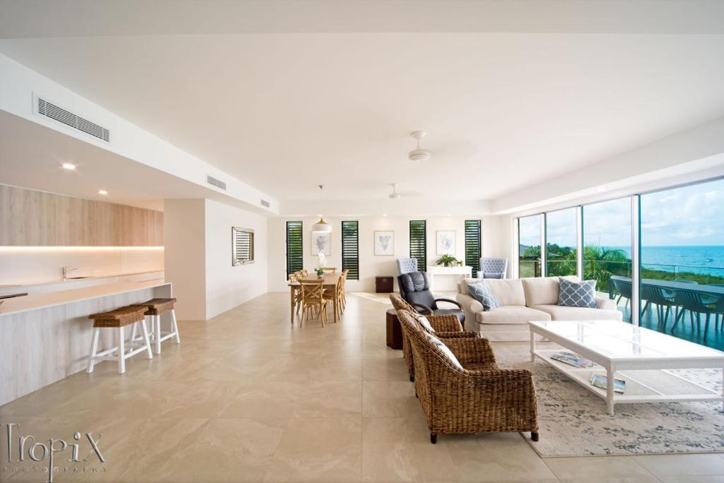 a living room with a couch and a table at Splendeur Sur La Mer - Two Bedroom in Cannonvale