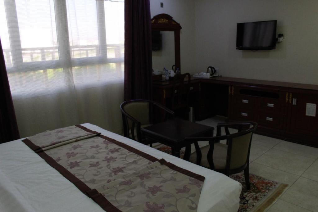 Postel nebo postele na pokoji v ubytování Al Diyar Hotel