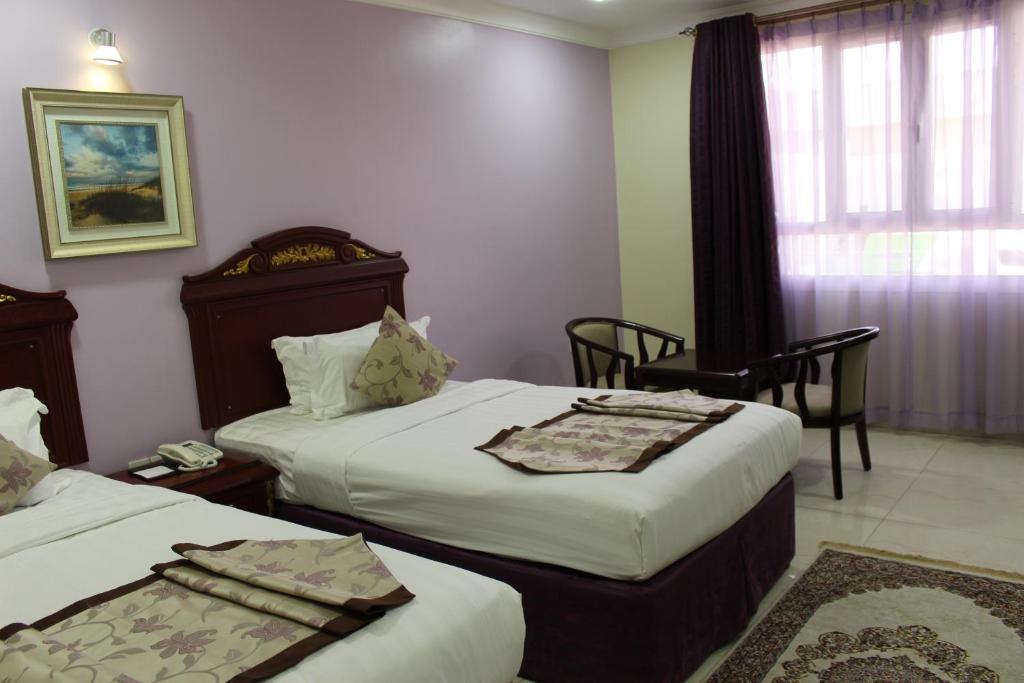 Postel nebo postele na pokoji v ubytování Al Diyar Hotel