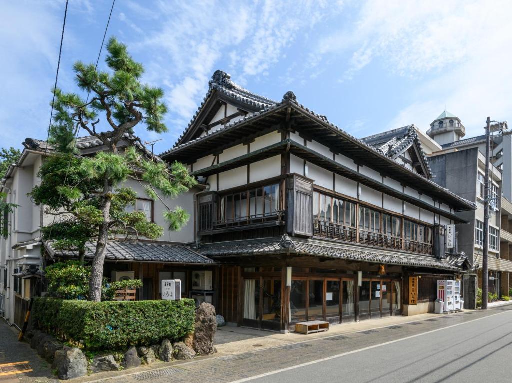 an asian style building on the side of a street at Tabist Asanokan Annex Iroha Ise in Ise