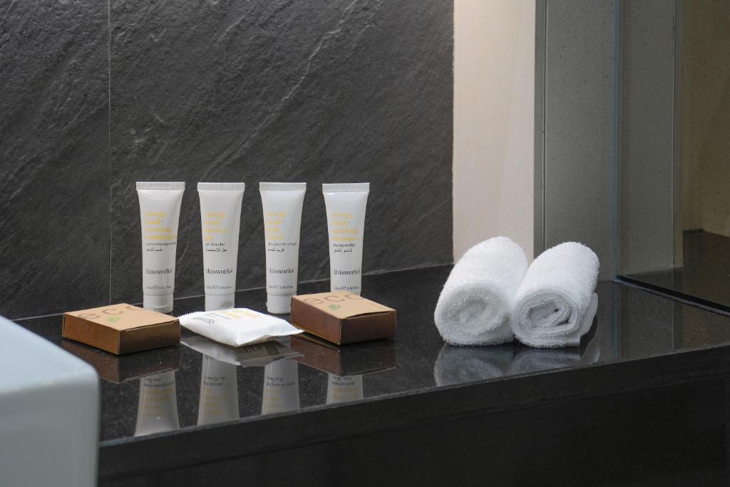 a group of vases sitting on a table with towels at Crowne Plaza Bahrain by IHG in Manama