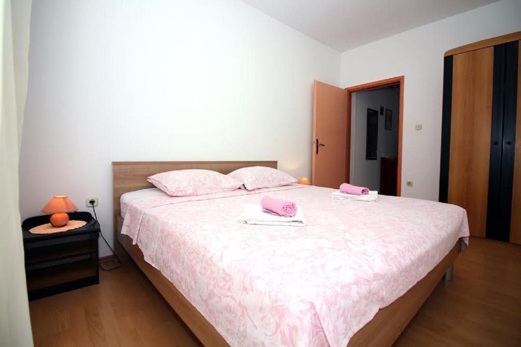 Postel nebo postele na pokoji v ubytování Apartmani Stanko