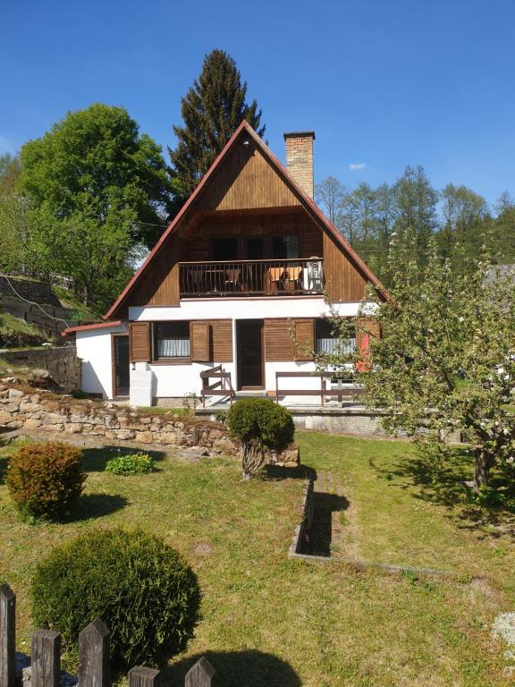 a large house with a fence in front of it at Chata Seeberg in Poustka