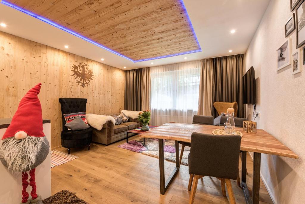 a living room with a gnome sitting on a table at Quality Hosts Arlberg - ALPtyrol Appartements in Sankt Anton am Arlberg