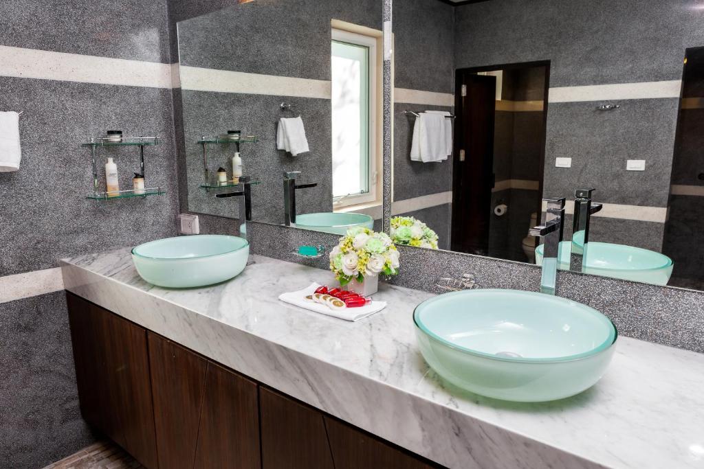 a bathroom with two sinks and a large mirror at Samui Sunrise Seaview Villa in Chaweng