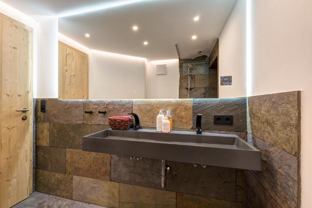 a kitchen with a sink in a room at Quality Hosts Arlberg - ALPtyrol Appartements in Sankt Anton am Arlberg