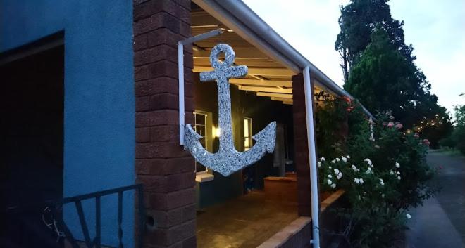 a large anchor sign on the front of a house at Anker Guesthouse in Philippolis