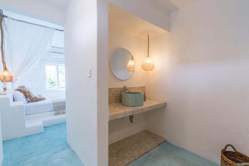 a bathroom with a sink and a mirror at Guru Canggu in Canggu