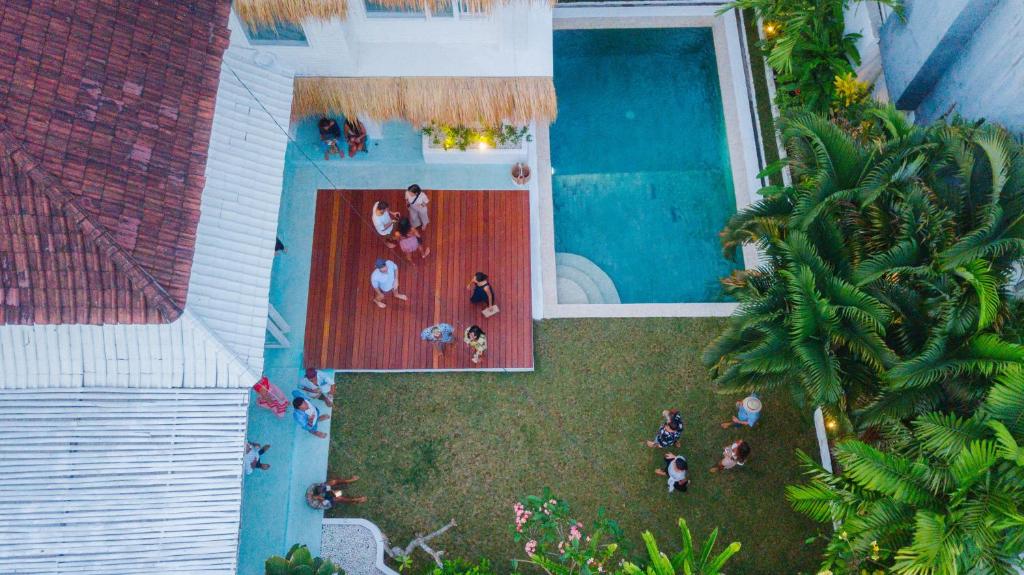 an overhead view of a swimming pool with people standing around it at Guru Canggu in Canggu