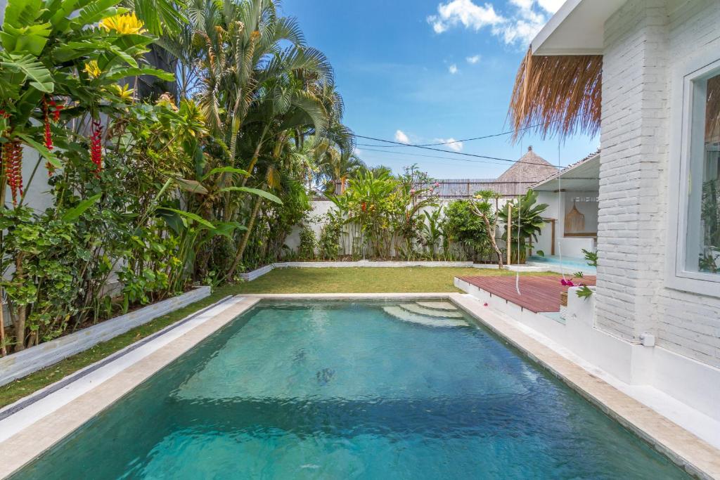 a swimming pool in the backyard of a house at Guru Canggu in Canggu