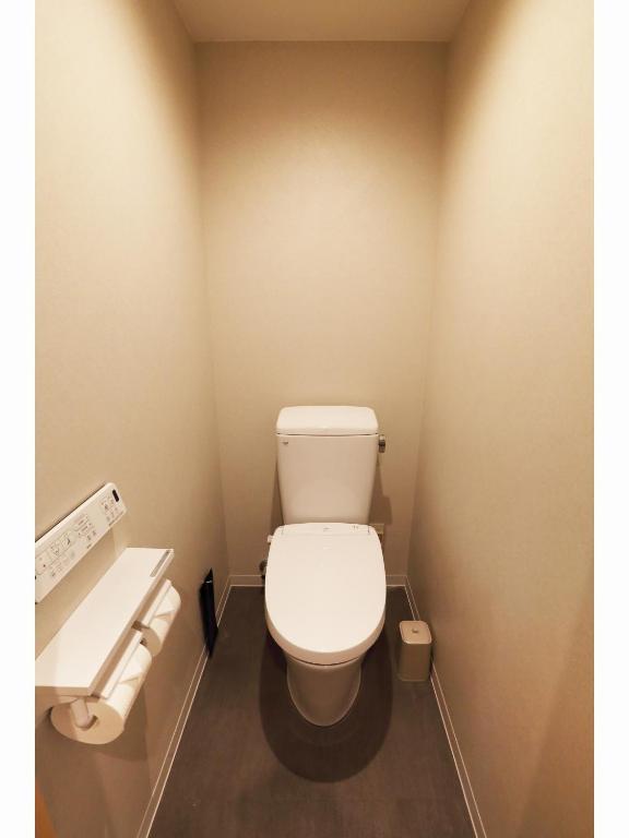 a bathroom with a white toilet in a stall at Henn na Hotel Premier Nara in Nara