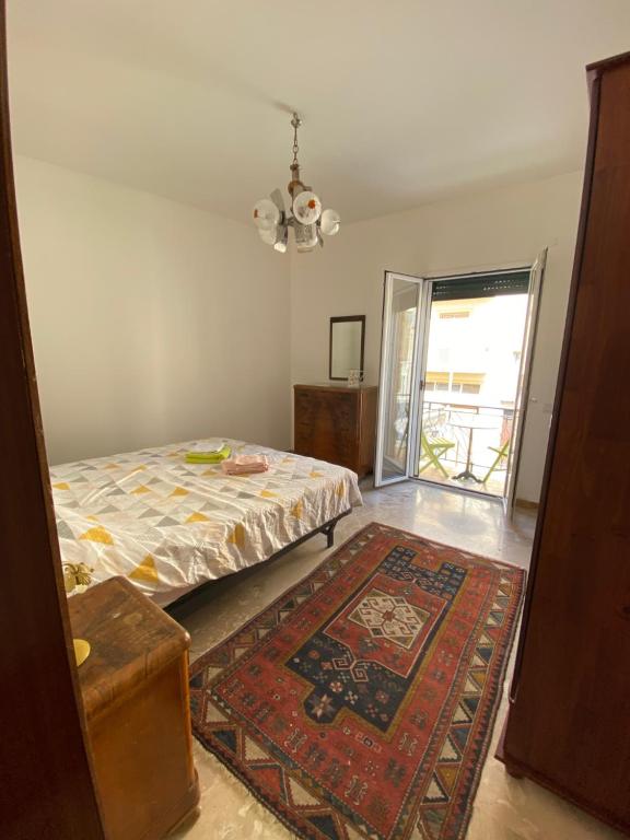 a bedroom with a bed and a rug at Vista Baglio Grande in Sambuca di Sicilia