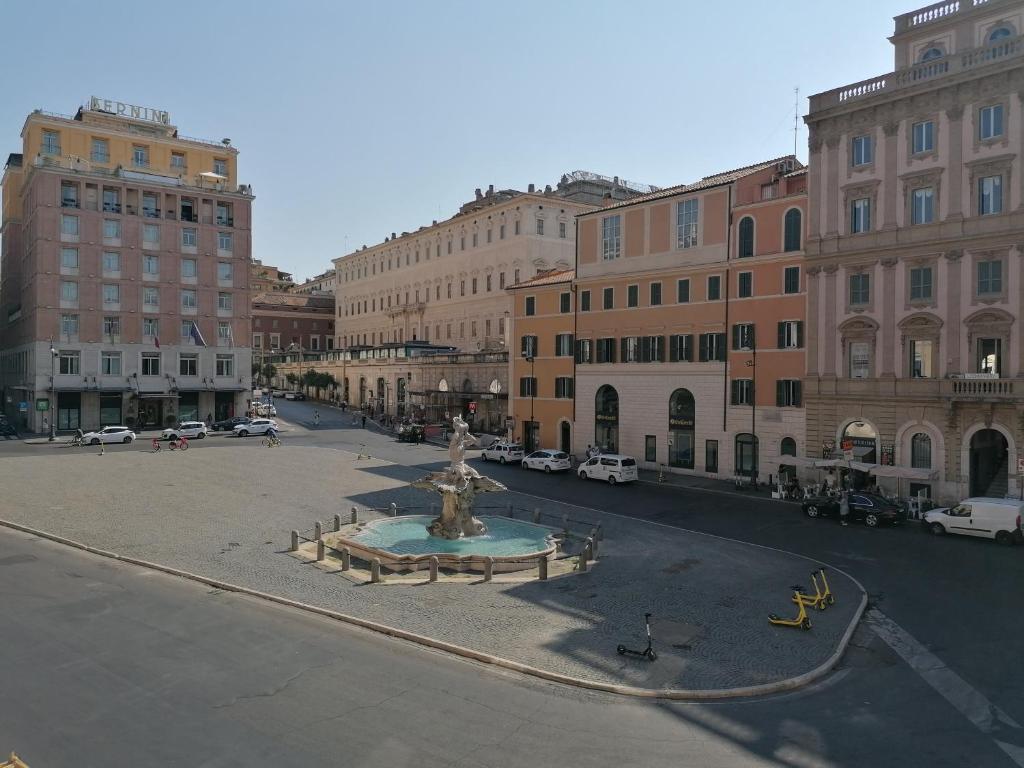 ulica z fontanną w środku miasta w obiekcie Bernini apartment w Rzymie
