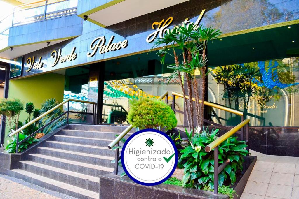 a restaurant with a sign in front of a building at Vale Verde Palace Hotel in Laranjal Paulista