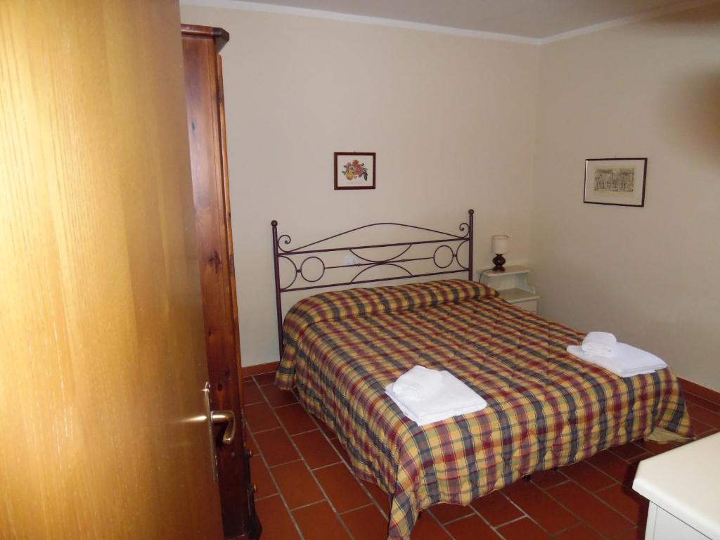 a bedroom with a bed with a plaid blanket at CASA PATRIZIA MONTAIONE in Montaione