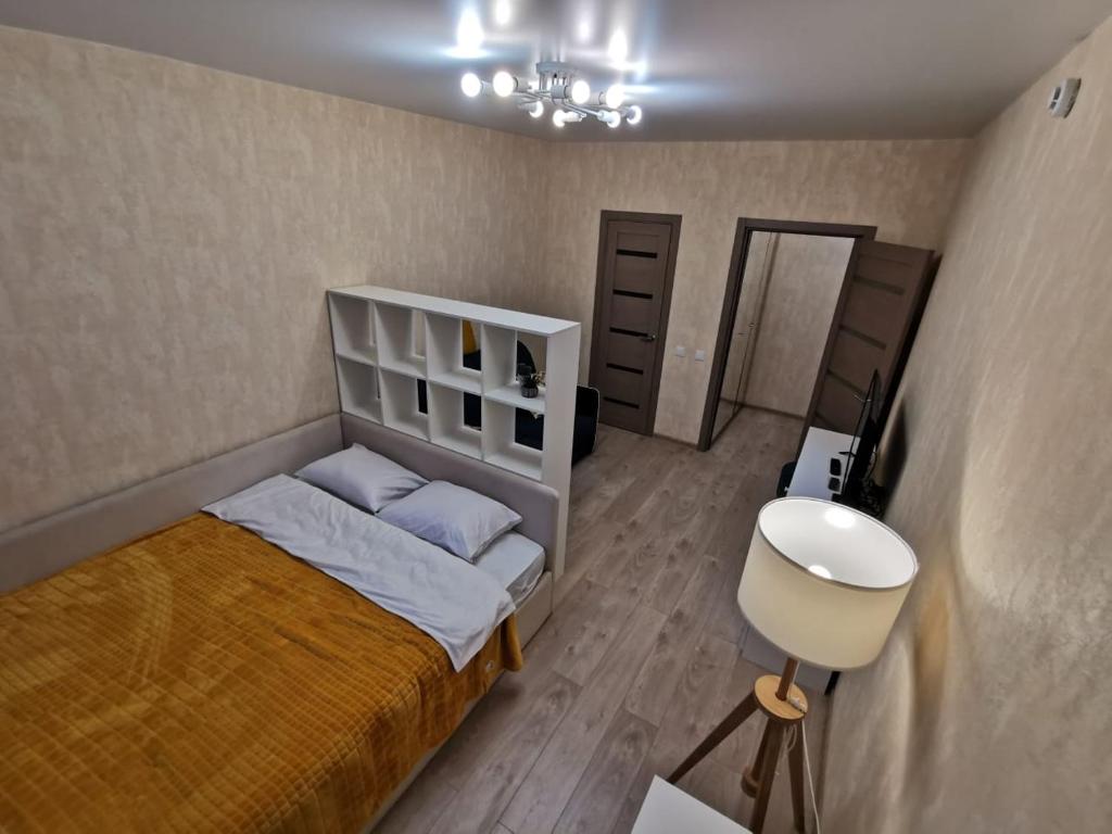 a small bedroom with a bed and a sink at Комфортабельные апартаменты. Добро пожаловать! in Tver