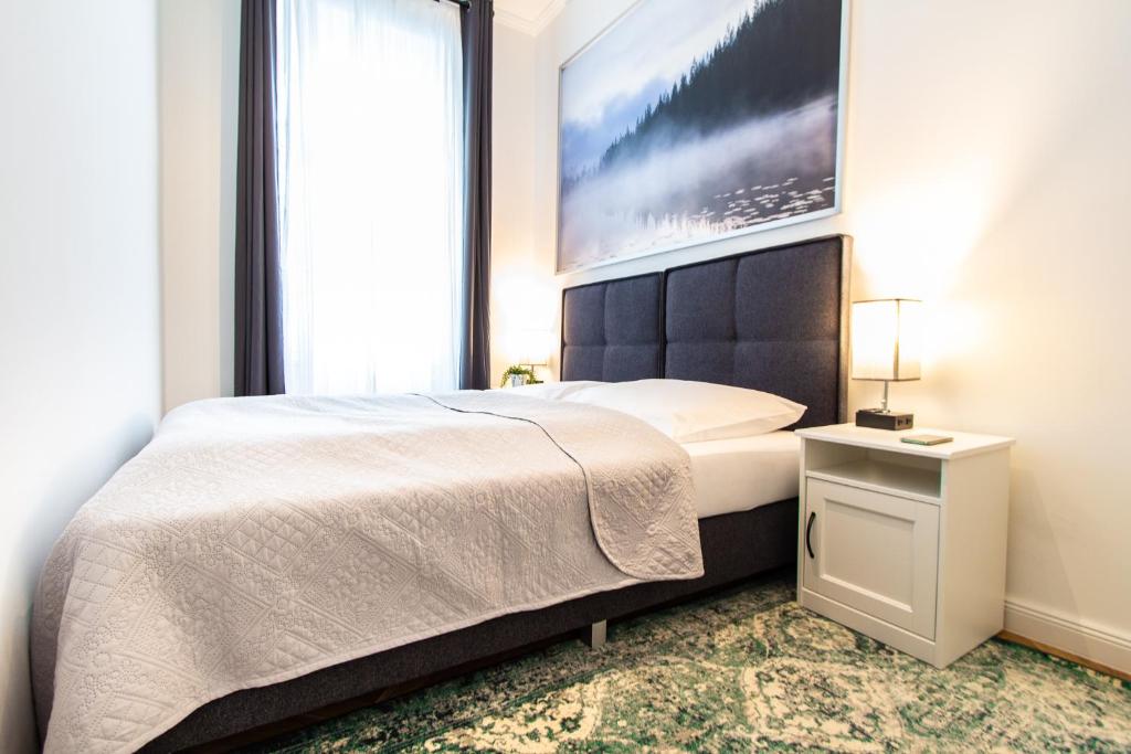 a bedroom with a large bed and a large window at Apartment Erdberg I contactless check-in in Vienna
