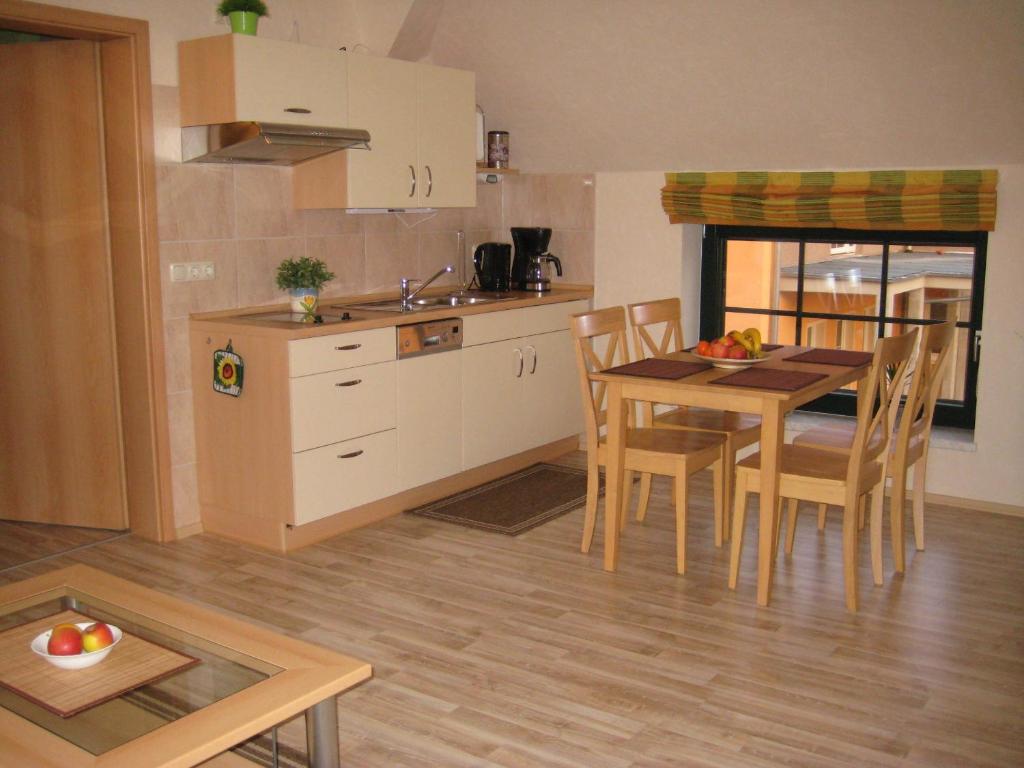 cocina y comedor con mesa y sillas en Storchenblick en Schlepzig
