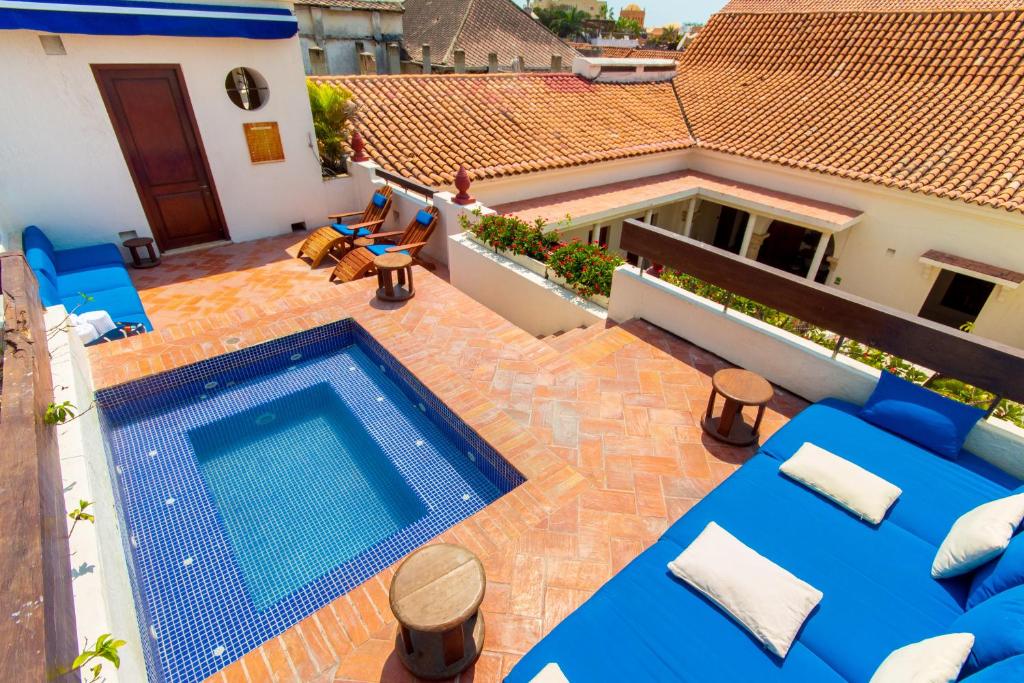 
a patio area with a pool table and chairs at Hotel Quadrifolio in Cartagena de Indias
