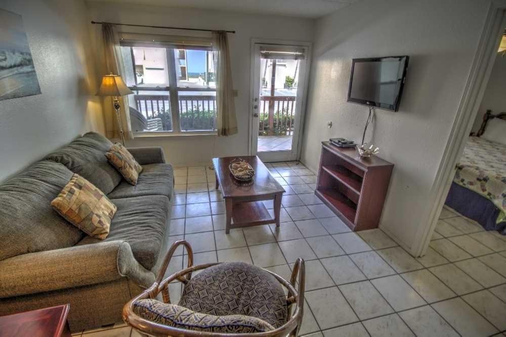 a living room with a couch and a tv at SURFSIDE II 107 condo in South Padre Island