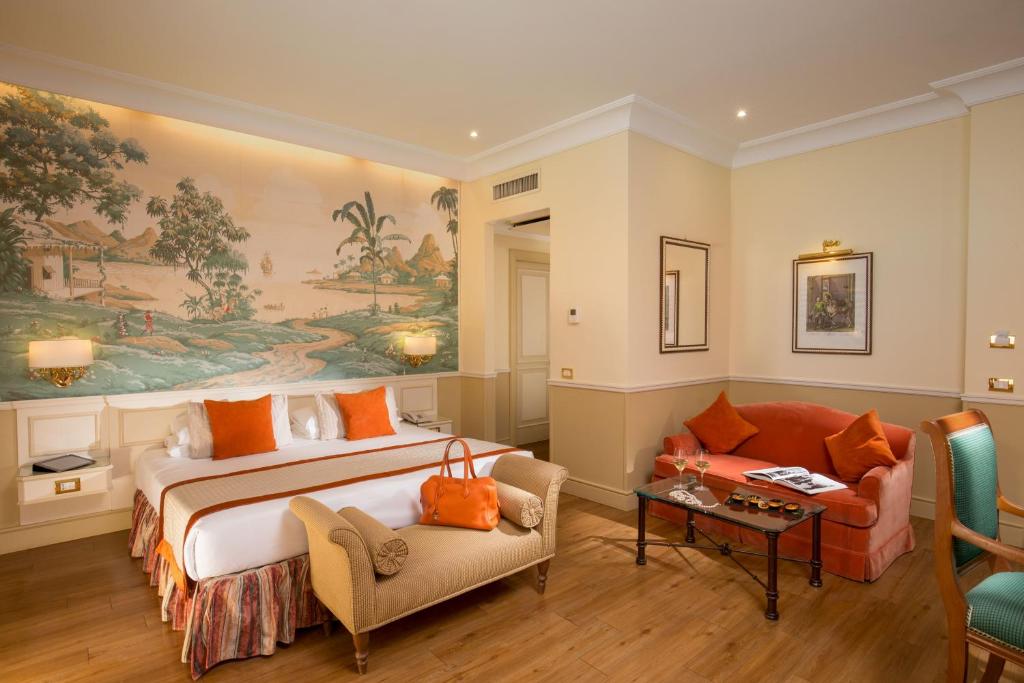 a hotel room with a bed and a couch at Donna Laura Palace by OMNIA hotels in Rome