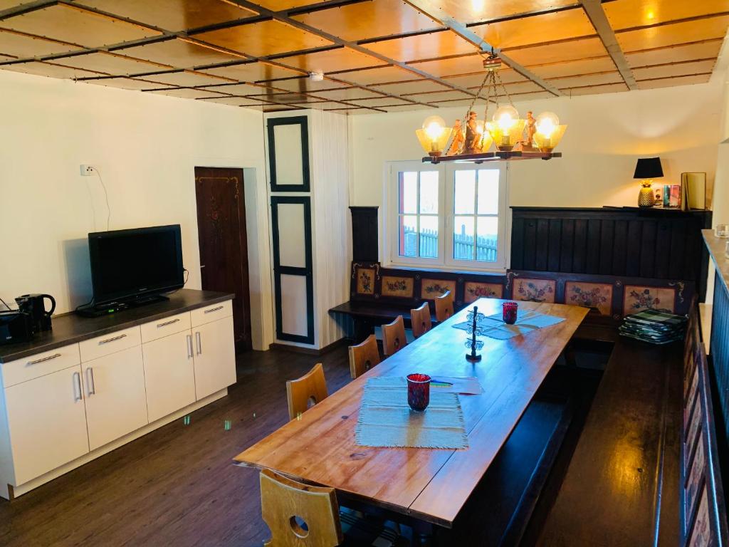 uma grande sala de jantar com uma mesa de madeira e cadeiras em Baude Steinheid am Rennsteig mit 12 Betten em Steinheid