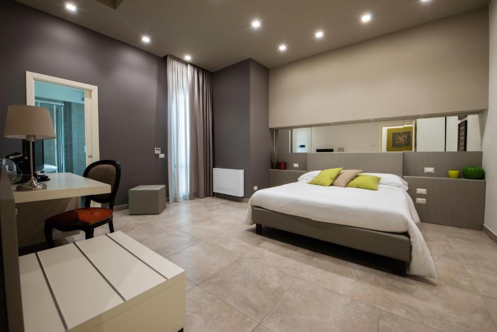 ein Schlafzimmer mit einem Bett und einem Schreibtisch. in der Unterkunft B&B Palazzo Paciotti in Trani