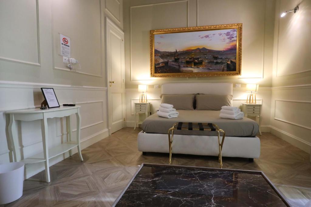 a bedroom with a bed and a painting on the wall at Vico Gelso Napoli in Naples