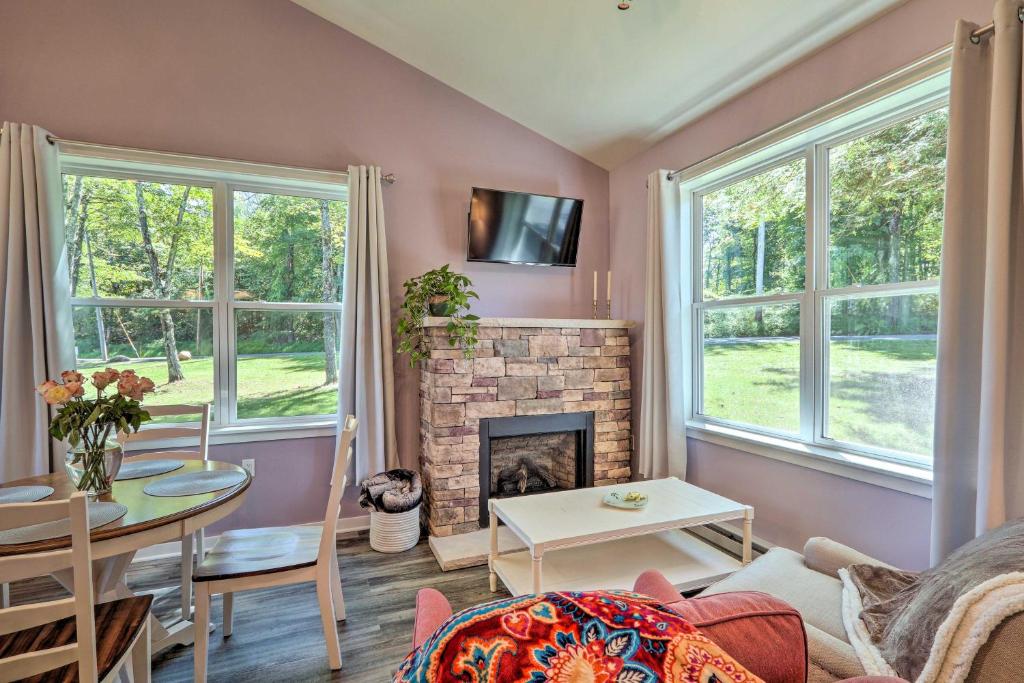 a living room with a fireplace and a table at Saylorsburg Retreat 16 Mi to Ski Resort in Saylorsburg