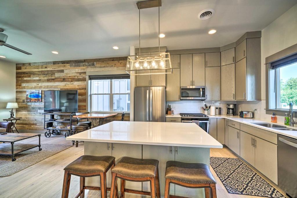 a large kitchen with a large white island with bar stools at Bozeman Stand-Alone Home with River Access! in Bozeman