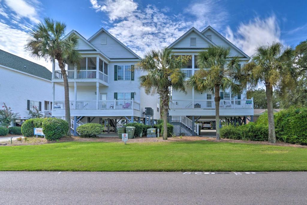 una gran casa blanca con palmeras delante en Surfside Beach Home Base Steps to Pool and Ocean! en Myrtle Beach