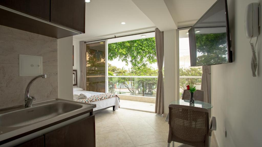 a kitchen with a sink and a large window at Hollywood Beach Suite in Cartagena de Indias