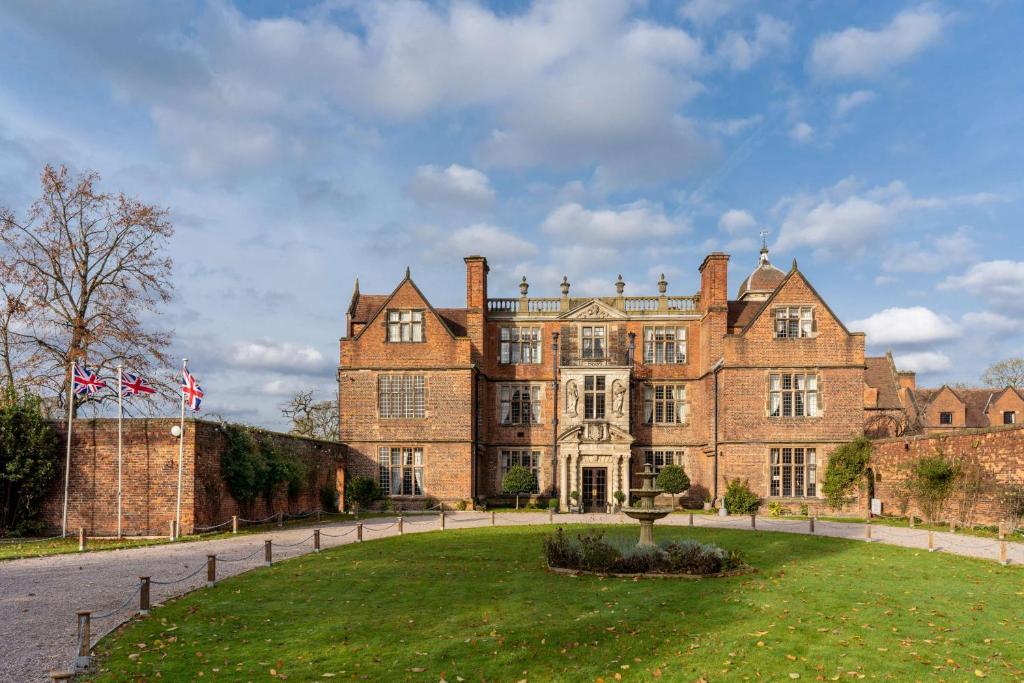 a large brick building with a fountain in front of it at Castle Bromwich Hall; Sure Hotel Collection by Best Western in Birmingham