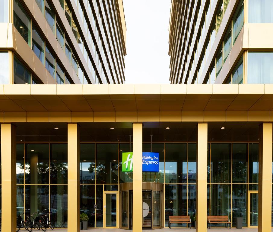 an office building with a sign in front of it at Holiday Inn Express Amsterdam - North Riverside by IHG in Amsterdam