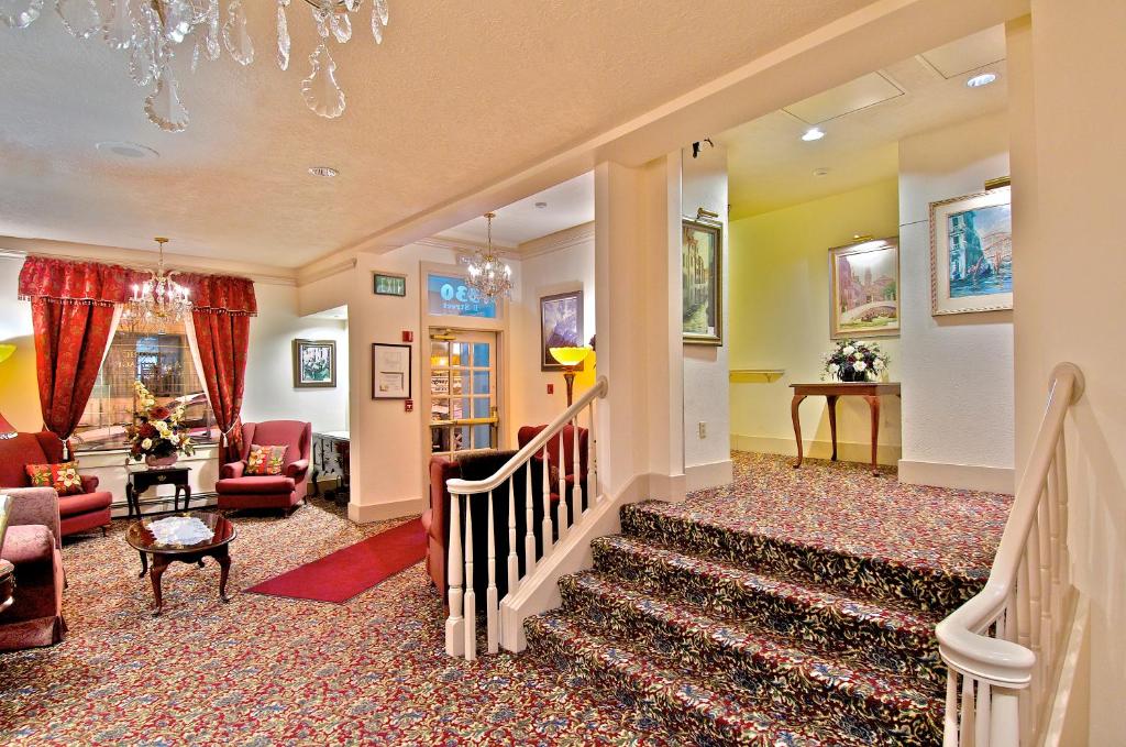 a living room filled with furniture and a stairway at Historic Anchorage Hotel in Anchorage