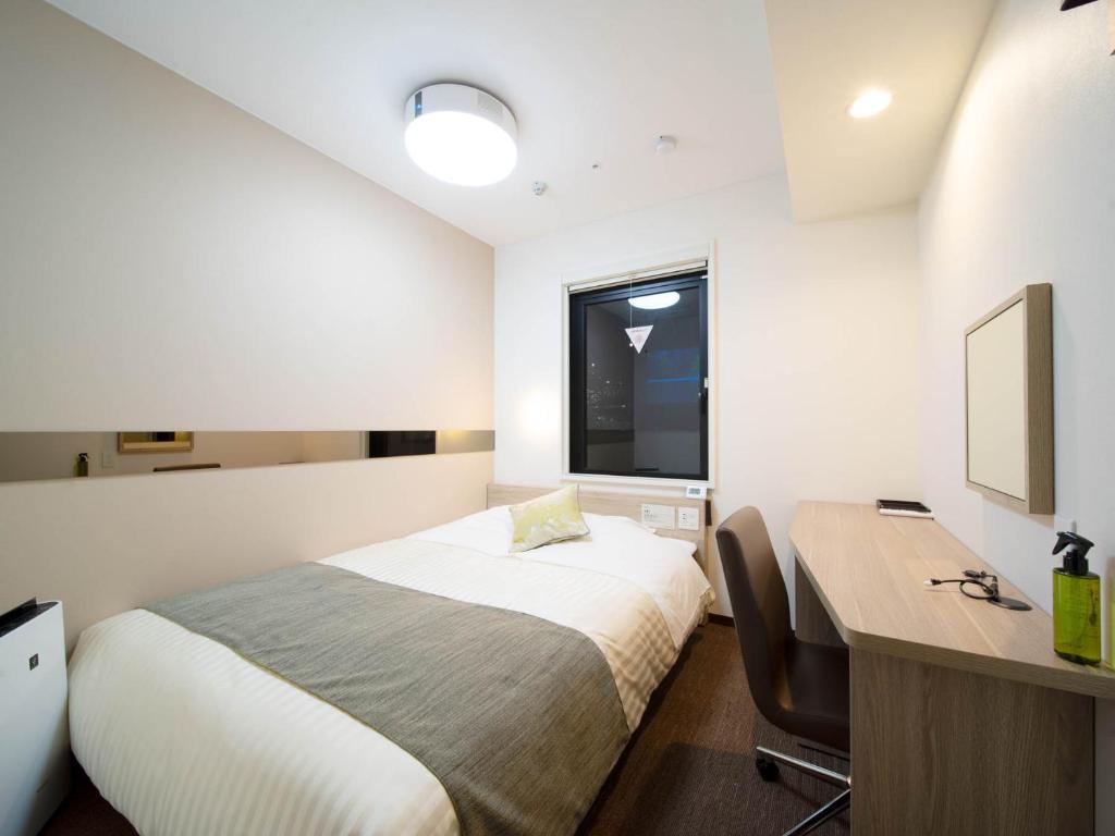 Postel nebo postele na pokoji v ubytování Super Hotel Tokyo Hamamatsucho